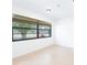Bright bedroom with tiled floors, natural light from a large window with wooden blinds, and neutral walls at 2369 Haulover Blvd, Deltona, FL 32738