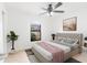 Cozy bedroom with a large window, ceiling fan, and a stylish bed, creating a relaxing and comfortable atmosphere at 2369 Haulover Blvd, Deltona, FL 32738