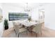 Inviting dining area with a modern chandelier and views of the pool through the large window at 2369 Haulover Blvd, Deltona, FL 32738