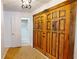 Foyer with decorative tiled flooring, large wooden closet doors and a view into a bathroom at 2369 Haulover Blvd, Deltona, FL 32738