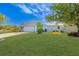 Side view of a single-story home featuring a well manicured lawn, garden beds and a two-car garage at 2369 Haulover Blvd, Deltona, FL 32738