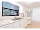 Bright kitchen with stainless steel sink, white cabinets, and stone countertops at 2369 Haulover Blvd, Deltona, FL 32738
