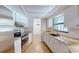 Well-lit kitchen with stainless steel appliances, stone countertops, and white cabinets at 2369 Haulover Blvd, Deltona, FL 32738