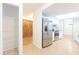 Bright kitchen features stainless steel appliances, white cabinets, and neutral tile flooring at 2369 Haulover Blvd, Deltona, FL 32738