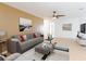 Relaxing living area featuring a modern sofa, neutral paint, ceiling fan, and stylish decorative touches at 2369 Haulover Blvd, Deltona, FL 32738