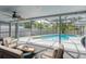 Relaxing screened pool area with a spacious patio and comfortable furniture for outdoor lounging at 2369 Haulover Blvd, Deltona, FL 32738