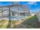 Screened-in pool and pool deck surrounded by well-maintained landscaping at 2369 Haulover Blvd, Deltona, FL 32738