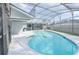 Inviting pool area surrounded by a screened enclosure and a paved patio at 2369 Haulover Blvd, Deltona, FL 32738