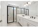 Modern bathroom featuring a double vanity, shower with black frame and tile walls at 2378 Addalia Aly, Orlando, FL 32804