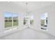 Sunlit dining area featuring modern chandelier, large windows with scenic views, and tile floors at 2378 Addalia Aly, Orlando, FL 32804