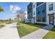 Modern townhome featuring a landscaped yard, neutral colors, and welcoming entryway at 2378 Addalia Aly, Orlando, FL 32804
