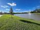 View of a pond with a water feature, sidewalks, and grass at 2378 Addalia Aly, Orlando, FL 32804