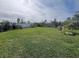 Expansive backyard featuring lush green grass, well-maintained landscaping, and a white fence for privacy at 2711 Neverland Dr, New Smyrna Beach, FL 32168