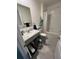 Well-lit bathroom featuring a single sink vanity, shower, and gray tile floors at 2711 Neverland Dr, New Smyrna Beach, FL 32168