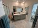 Bathroom with double sinks, a large mirror, and a separate glass-enclosed shower at 2711 Neverland Dr, New Smyrna Beach, FL 32168
