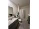 Bright bathroom with a single sink vanity, and a shower-tub combo with neutral colored walls at 2711 Neverland Dr, New Smyrna Beach, FL 32168