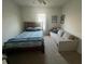 Bedroom with carpeted floors, window with blinds, and a bed and couch for ample seating at 2711 Neverland Dr, New Smyrna Beach, FL 32168
