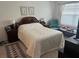 Bedroom with a queen bed, carpet, and a chair near the window at 2711 Neverland Dr, New Smyrna Beach, FL 32168