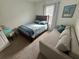 Comfortable bedroom with a full bed, sofa, and window at 2711 Neverland Dr, New Smyrna Beach, FL 32168