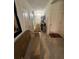 Hallway with neutral tiled floors, decorative art, and a seating area for a cozy home at 2711 Neverland Dr, New Smyrna Beach, FL 32168