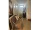 Welcoming hallway with neutral tiled floors, a decorative bench, and access to various rooms at 2711 Neverland Dr, New Smyrna Beach, FL 32168
