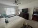 Bright bedroom with a large bed, a ceiling fan, and ample natural light from the window at 2711 Neverland Dr, New Smyrna Beach, FL 32168