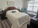 Cozy main bedroom with ample sunlight, a bed, and comfortable seating arrangement at 2711 Neverland Dr, New Smyrna Beach, FL 32168