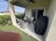 Relaxing covered patio area with comfortable wicker furniture and a grill at 2711 Neverland Dr, New Smyrna Beach, FL 32168