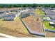 Wide aerial view of a backyard with a fence and playground in a residential neighborhood with a tree lined perimeter at 2995 Flying Blackbird Rd, Bartow, FL 33830