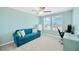 Well-lit bedroom with comfortable blue sofa, desk and two windows overlooking the neighborhood at 2995 Flying Blackbird Rd, Bartow, FL 33830