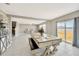 Open-concept dining room with modern table, sliding glass doors to the back yard, and access to the stairwell at 2995 Flying Blackbird Rd, Bartow, FL 33830