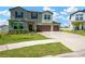 Charming two-story home with a lush green lawn and attached two-car garage at 2995 Flying Blackbird Rd, Bartow, FL 33830