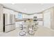 Bright kitchen features white cabinets, stainless steel appliances, granite countertops and large center island with seating at 2995 Flying Blackbird Rd, Bartow, FL 33830