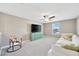 Upstairs living room includes a comfortable white sofa and mounted TV at 2995 Flying Blackbird Rd, Bartow, FL 33830