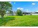 View of the lush green backyard, the house, and a shed at 3379 Monika Cir, Orlando, FL 32812