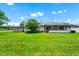 View of the lush green backyard and the house at 3379 Monika Cir, Orlando, FL 32812