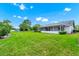View of the lush green backyard and the house at 3379 Monika Cir, Orlando, FL 32812