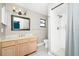 Bathroom with a single sink vanity, toilet, shower with curtain, and tiled floor at 3379 Monika Cir, Orlando, FL 32812