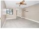 Bedroom with ceiling fan, tile floors, window and sliding mirrored closet doors at 3379 Monika Cir, Orlando, FL 32812