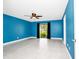 Bedroom with tiled floor, blue walls, ceiling fan and sliding glass doors to the exterior at 3379 Monika Cir, Orlando, FL 32812
