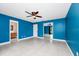Spacious bedroom with blue walls, ceiling fan, and sliding mirror closet doors at 3379 Monika Cir, Orlando, FL 32812