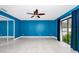 Bedroom with tile flooring, blue walls, a ceiling fan, sliding glass doors, and closet at 3379 Monika Cir, Orlando, FL 32812