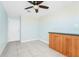 This bedroom features light blue walls, built-in wooden cabinets, and neutral tile flooring at 3379 Monika Cir, Orlando, FL 32812