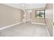 Bedroom with ceiling fan, tile floors, window and sliding mirrored closet doors at 3379 Monika Cir, Orlando, FL 32812