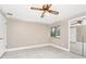 Bedroom with ceiling fan, tile floors, window and sliding mirrored closet doors at 3379 Monika Cir, Orlando, FL 32812
