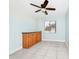 Bedroom with a storage cabinet, ceiling fan, tile floors, and window at 3379 Monika Cir, Orlando, FL 32812