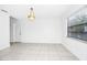 Bright dining room with tile flooring and a view of the adjacent door and window with blinds at 3379 Monika Cir, Orlando, FL 32812