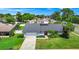 Charming single-story home with manicured lawn, lush landscaping, and a two-car garage at 3379 Monika Cir, Orlando, FL 32812