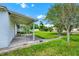 Outdoor space featuring a covered patio and a large tree, perfect for enjoying the serene surroundings at 3379 Monika Cir, Orlando, FL 32812