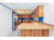 Bright kitchen features wood cabinetry, stainless steel appliances, tile flooring, and a breakfast bar at 3379 Monika Cir, Orlando, FL 32812